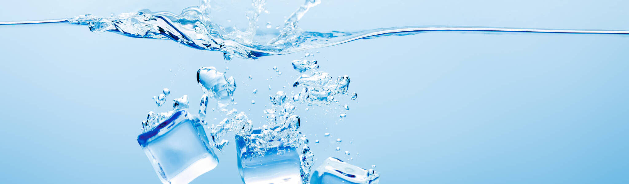 Transparent Pure Water With Splash And Ice On Blue Background